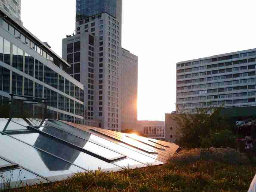Sonnenuntergang zwischen zwei Hochhäusern, Reflektion auf gläserner Dachschräge